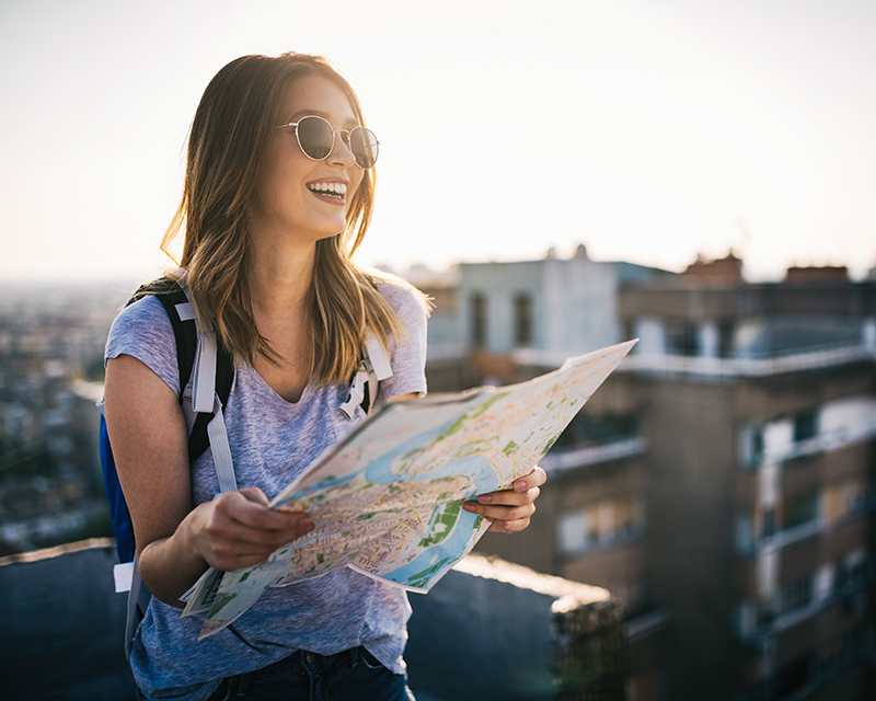 Woman traveling solo holding a map