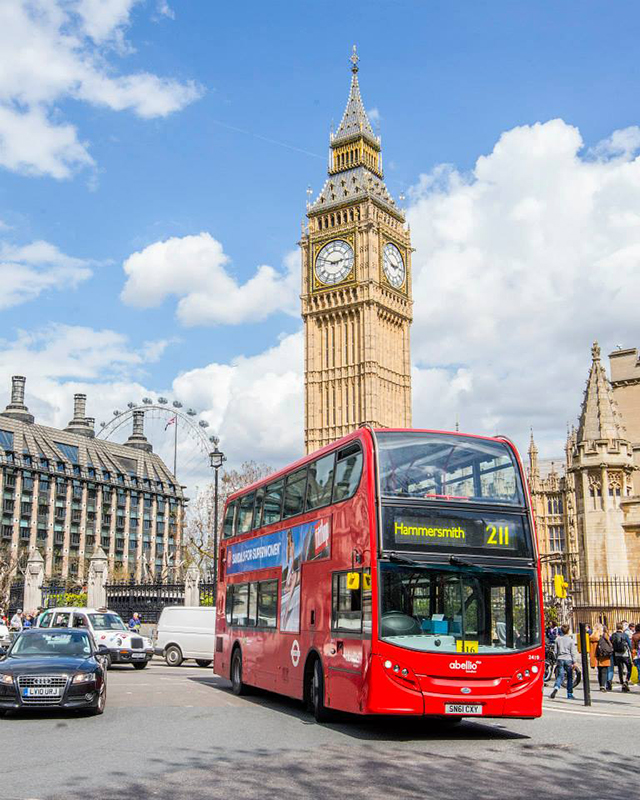 Downtown London with Big Ben and a red double decker bus: travel bucket list before 30