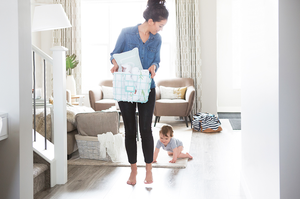 child crawling behind woman