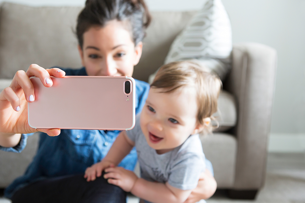 woman taking a picture with a child