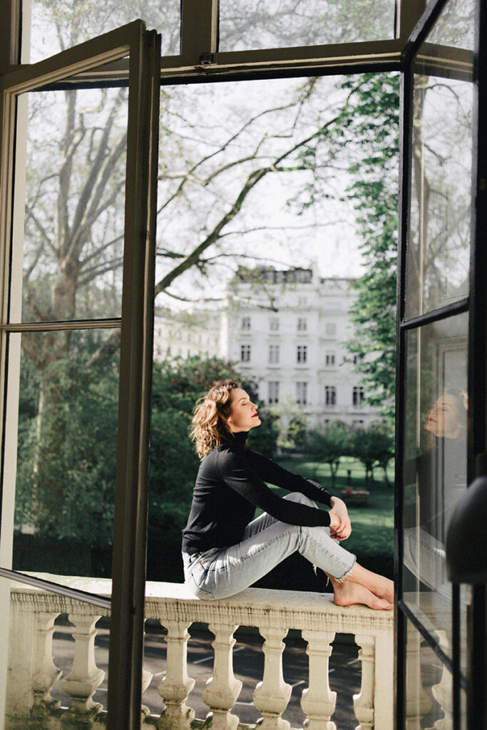 Woman sitting outside on a balcony